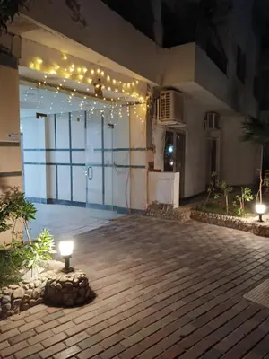 a large building with a large glass door with lights at Studio Lotus Compound Kawser in Hurghada