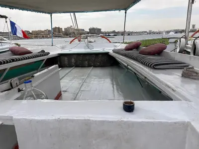 a boat with a table and a cup on it at Aswan felucca sailing boat in Aswān