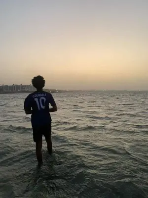a man standing in the water in the ocean at Sun live Holiday in Hurghada