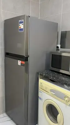a kitchen with a microwave and a washing machine at Sun live Holiday in Hurghada