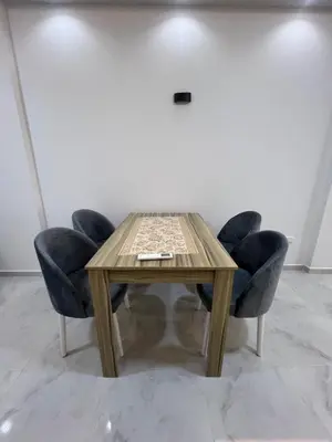 a wooden table with two blue chairs around it at Modern Beachfront Apartment 2 in Hurghada