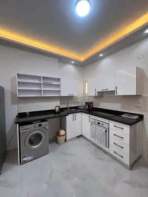 a kitchen with a washer and a washing machine at Modern Beachfront Apartment 2 in Hurghada