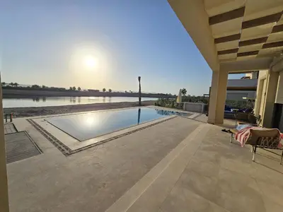 a swimming pool in the middle of a house at Villa at Cyan Ring with infinity pool at lagoon in Hurghada