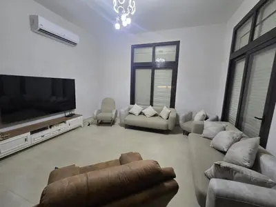 a living room with couches and a flat screen tv at Villa at Cyan Ring with infinity pool at lagoon in Hurghada