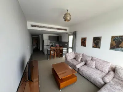a living room with a couch and a table at Bright 2Bdr with Stunning Pool Views – Sholan 1 in Hurghada