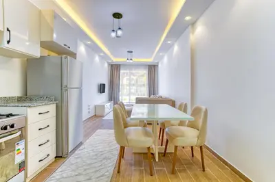 a kitchen and dining room with a table and chairs at Al Saraya Sahl Hasheesh by Peaks 1 Bed Apartment with Pool View C116 in Hurghada