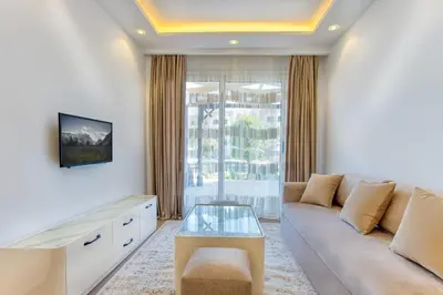 a living room with a couch and a window at Al Saraya Sahl Hasheesh by Peaks 1 Bed Apartment with Pool View C116 in Hurghada