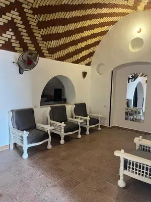 a room with three chairs and a ceiling with at Habu Palace in Luxor