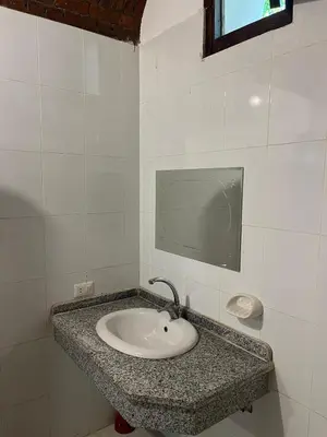 a bathroom with a sink and a tv on the wall at Habu Palace in Luxor