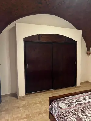 a large black cabinet in a room with a floor at Habu Palace in Luxor