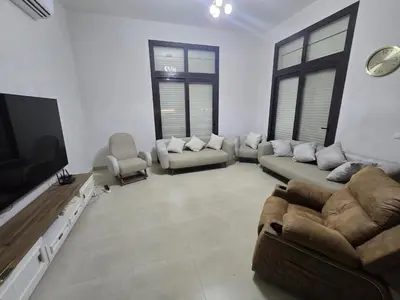 a living room with a couch and a flat screen tv at El Gouna Cyan Ringe Villa with infinity pool in Hurghada