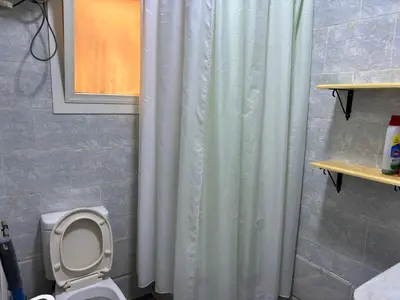 a bathroom with a shower curtain and a toilet at Apartment in Elhilal, Hurghada in Hurghada