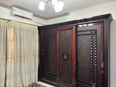 a pair of wooden doors in a room at Apartment in Elhilal, Hurghada in Hurghada