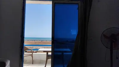 an open door to a view of the beach from a room at Oasis Marena in Hurghada