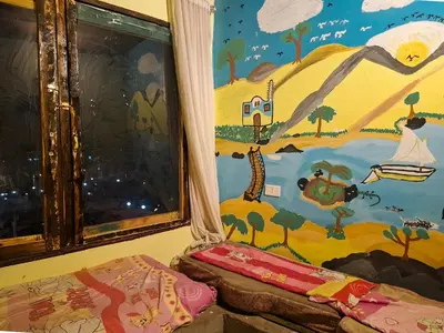 a room with a painting on the wall at Nubian Home by Sara in Nag` el-Ramla