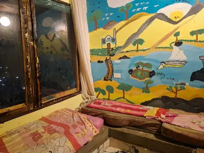 a room with a painting on the wall at Nubian Home by Sara in Nag` el-Ramla