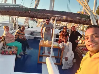 a group of people sitting on a boat at Mary sailboat adventure in Luxor