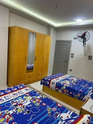 a bedroom with two beds and a basketball hoop at Elite Apartment Hurghada in Hurghada