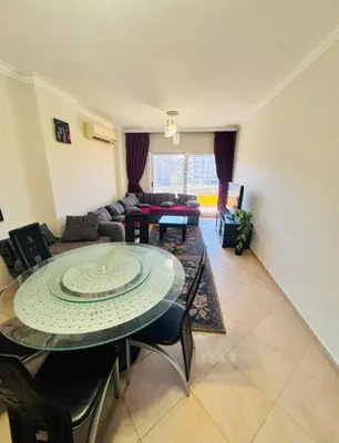 a living room with a table and a couch at Elegant 2BR Retreat in Secure Resort Community in Hurghada