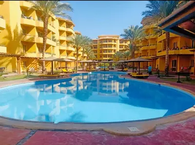 a large swimming pool in front of a hotel at Elegant 2BR Retreat in Secure Resort Community in Hurghada