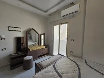 a bedroom with a bed and a dresser and a mirror at Redsea - Hrghada - Arabia in Hurghada