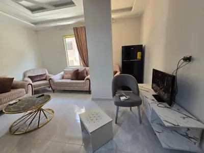 a living room with a couch and a table at Redsea - Hrghada - Arabia in Hurghada