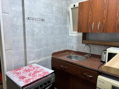 a small kitchen with a sink and a stove at Waleed in Hurghada