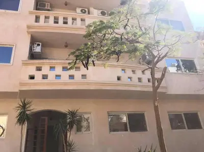 a building with a tree in front of it at Waleed in Hurghada