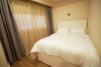 a bedroom with a white bed and a window at nile view modern studio- 7 min from aswan station in Aswan