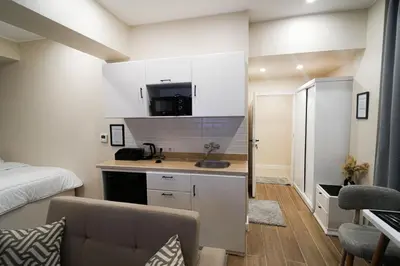 a small kitchen with a sink and a bed in a room at nile view modern studio- 7 min from aswan station in Aswan