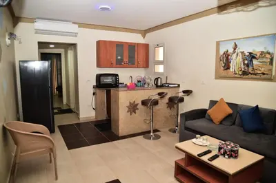 a living room with a couch and a kitchen at Al karma aqua beach in Hurghada