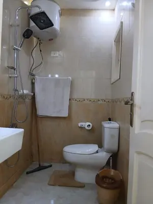 a bathroom with a toilet and a sink and a shower at عرابيا امام فندق بيروت بجوار سوبر ماركت الخضري in Hurghada