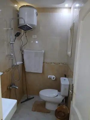 a small bathroom with a toilet and a sink at عرابيا امام فندق بيروت بجوار سوبر ماركت الخضري in Hurghada