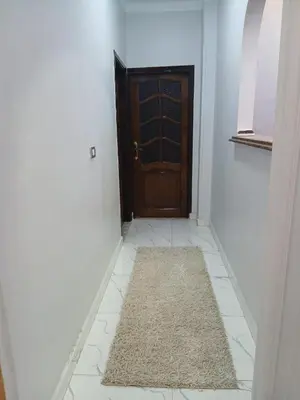 a hallway with a door and a rug on the floor at الشيراتون شارع السنترال السياحي in Hurghada