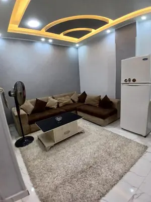 a living room with a couch and a refrigerator at الشيراتون شارع السنترال السياحي in Hurghada