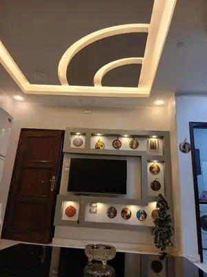a living room with a flat screen tv on a wall at الشيراتون شارع السنترال السياحي in Hurghada
