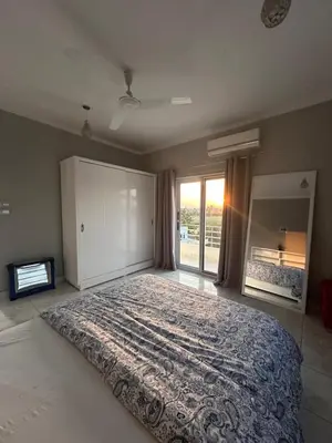 a bedroom with a large bed and a large window at Nile Spirit View in Luxor