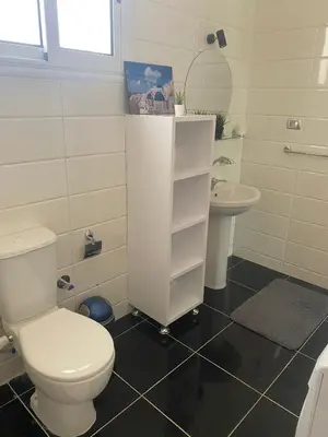 a white bathroom with a toilet and a sink at Nile Spirit View in Luxor