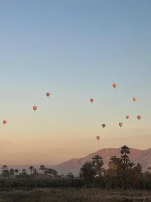 a group of hot air balloons flying in the sky at Nile Spirit View in Luxor