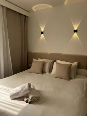 a bedroom with a white bed with towels on it at Royal Club Residence in Port Ghalib