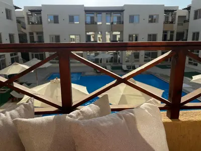 a view of a pool from a balcony of a building at Royal Club Residence in Port Ghalib