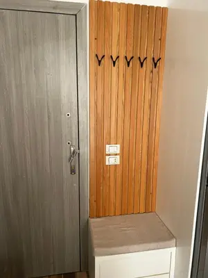 a wooden door with a bench in front of it at Royal Club Residence in Port Ghalib