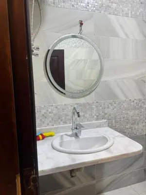 a bathroom with a sink and a mirror at Two Bedroom Apartment in Hurghada