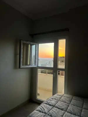 a bedroom with a bed and a window with a view at Poraa roof in Hurghada