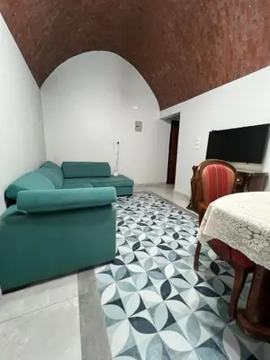 a living room with a couch and a table at Poraa roof in Hurghada