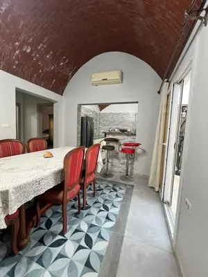 a kitchen and dining room with a table and chairs at Poraa roof in Hurghada
