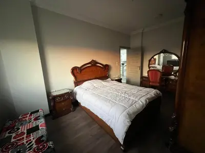 a bedroom with a large bed and a large mirror at Poraa roof in Hurghada