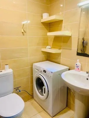 a bathroom with a washing machine and a sink at nice apartment in Hurghada
