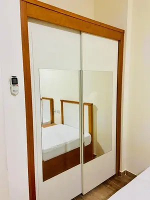 a glass closet with a bed inside of it at nice apartment in Hurghada