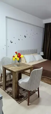 a room with a table and chairs and a bed at Bay View, Sahl Hashish in Hurghada